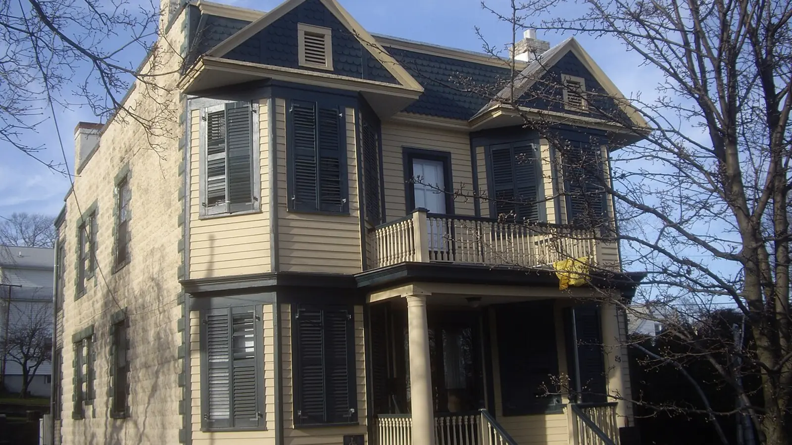 Older two-family Victorian-style house viewed from the street.